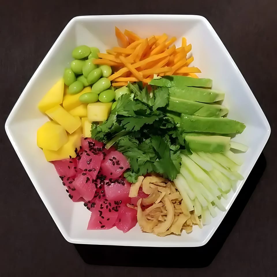 Blue Koi Sushi poke bowl with tuna, mango, edamame, carrots, avocado, cilantro, and cucumber.