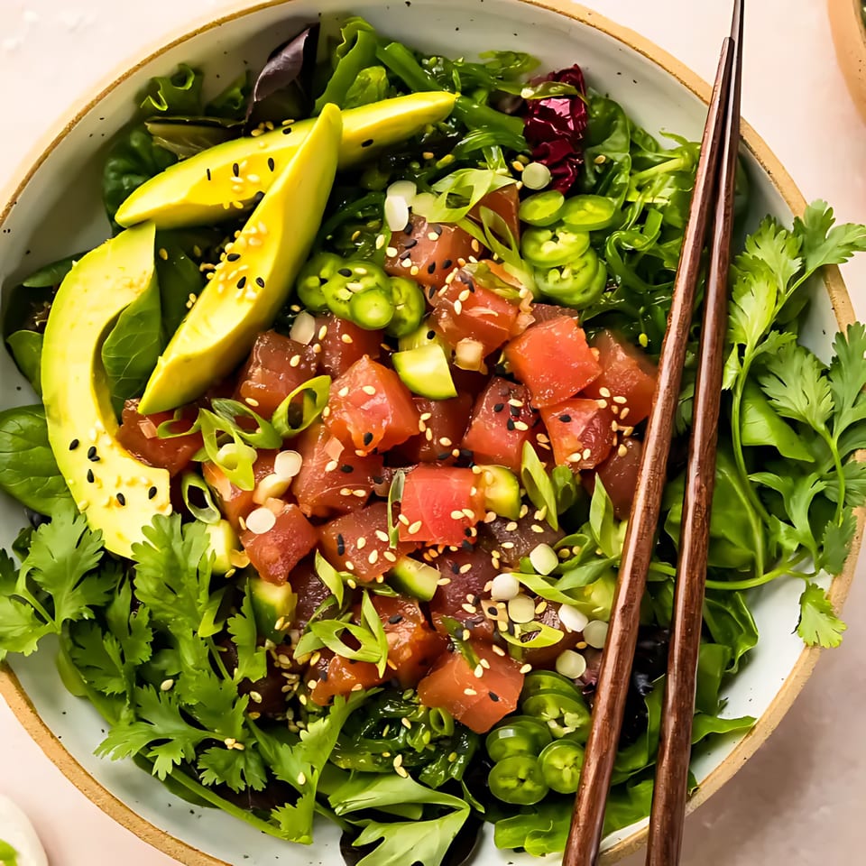 Blue Koi Sushi poke bowl with tuna, avocado, jalapenos, and greens, with chopsticks.